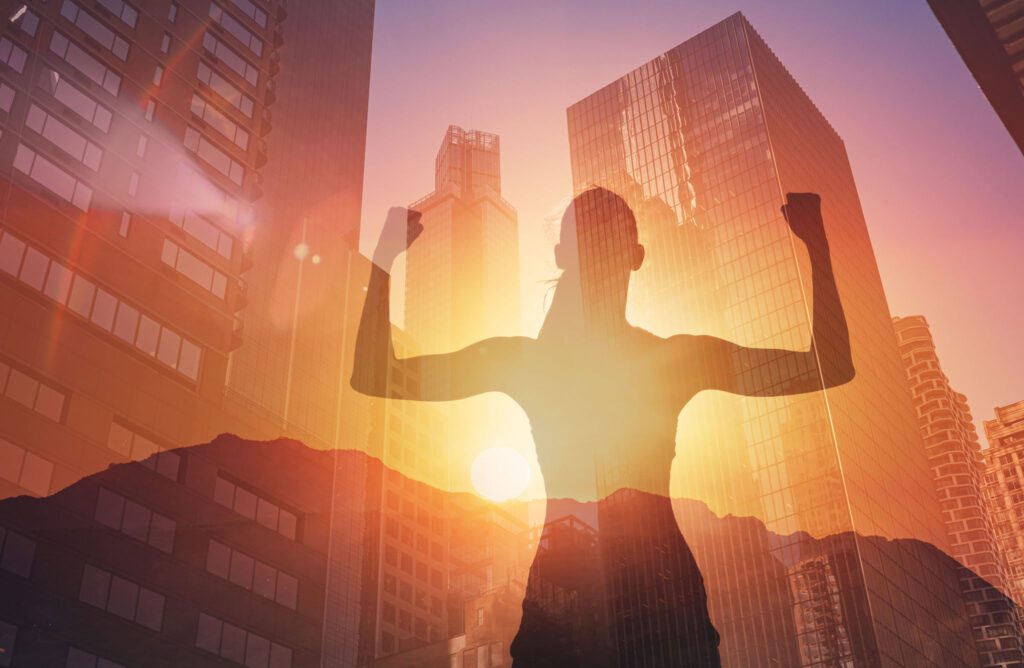 Silhouette of person with cityscape background.